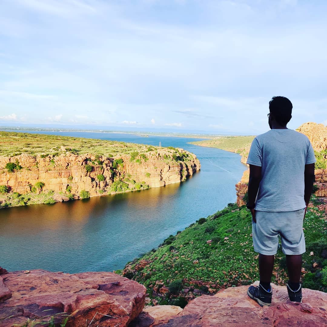 Dani Akash overlooking a river gorge on a hike