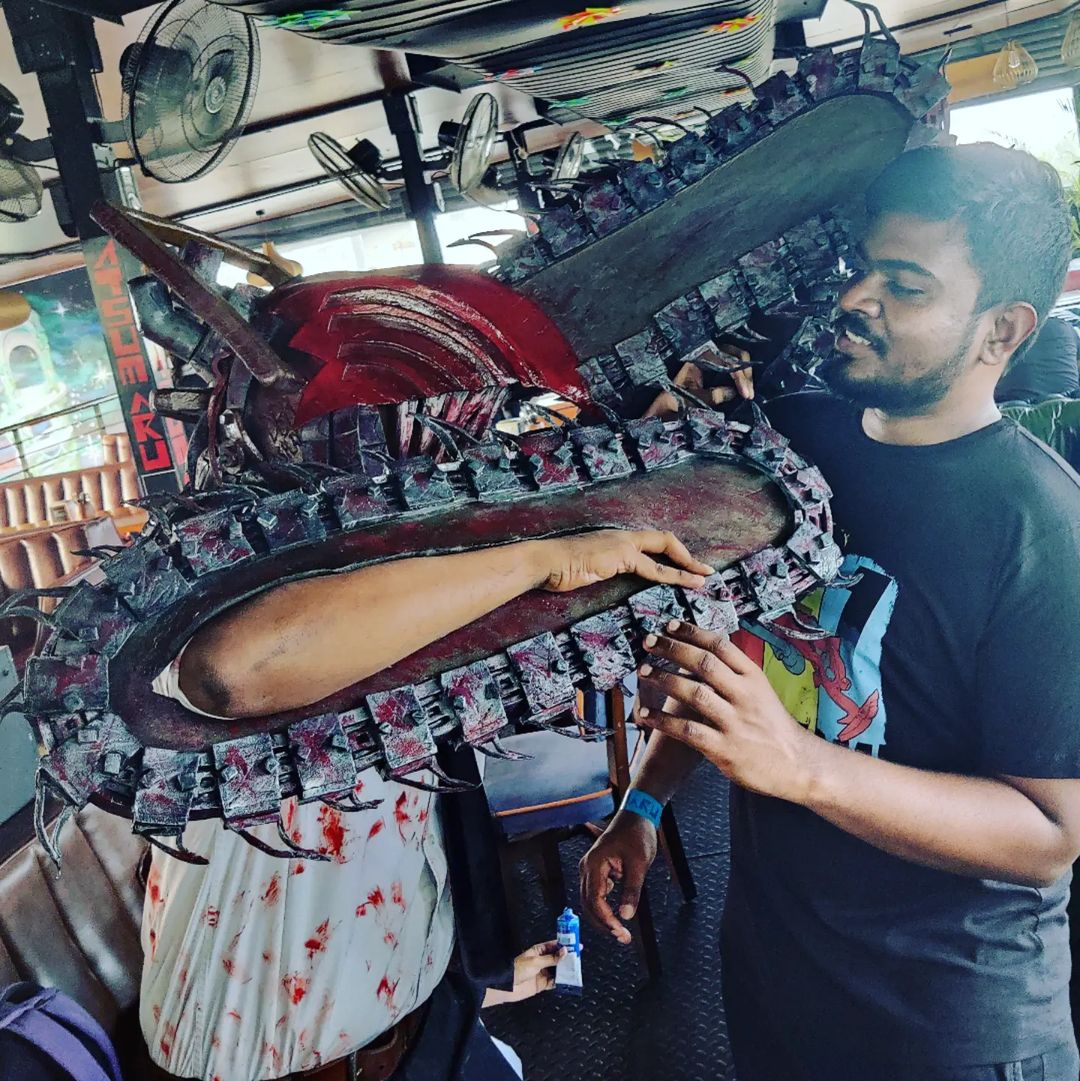 Dani Akash examining a large decorative sculpture at a market